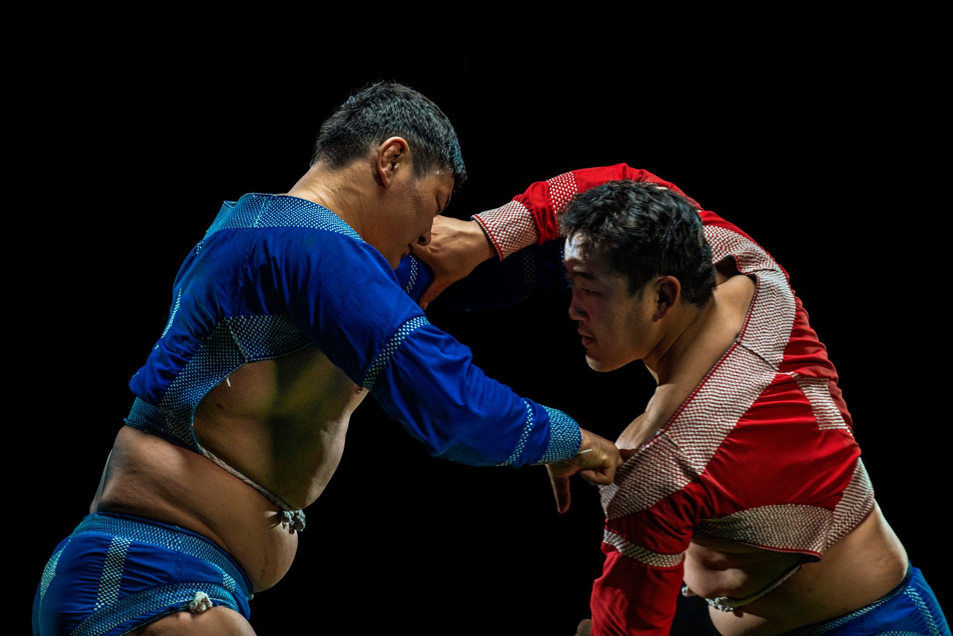 Two Mongolian wrestlers in traditional studded zodog armor